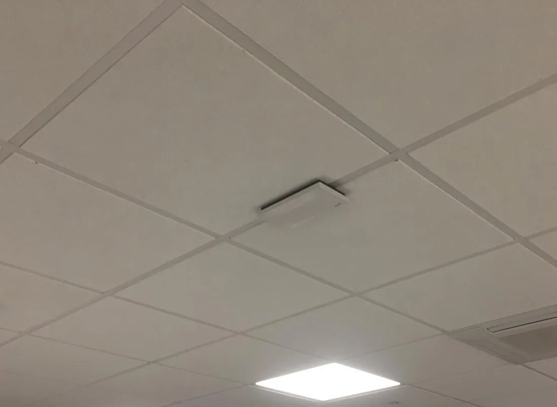 Ceiling-mounted wireless access point installed on a commercial site